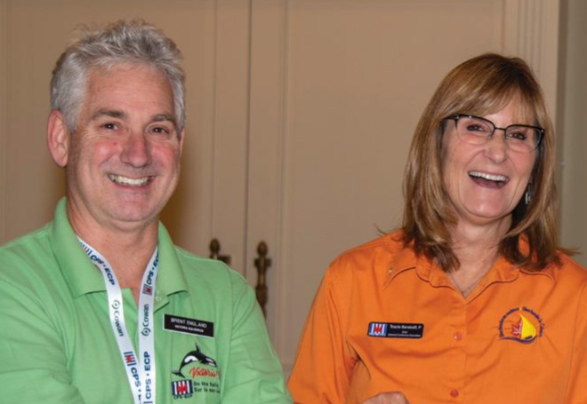 a man and woman wearing colourful tshirts with CPS-ECP logos